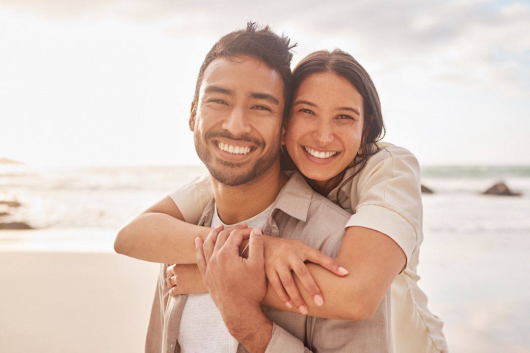 Couple smiling together at the beach