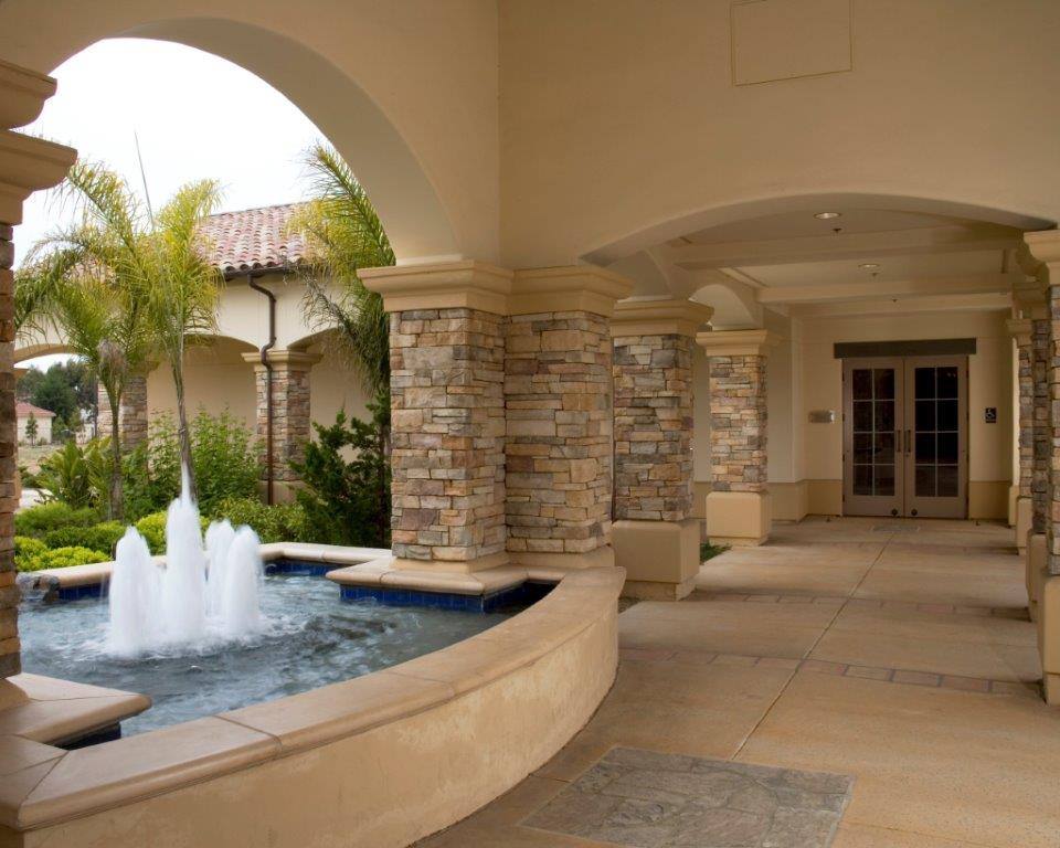 Arched courtyard with a stone fountain outside the NEXT Dentistry office