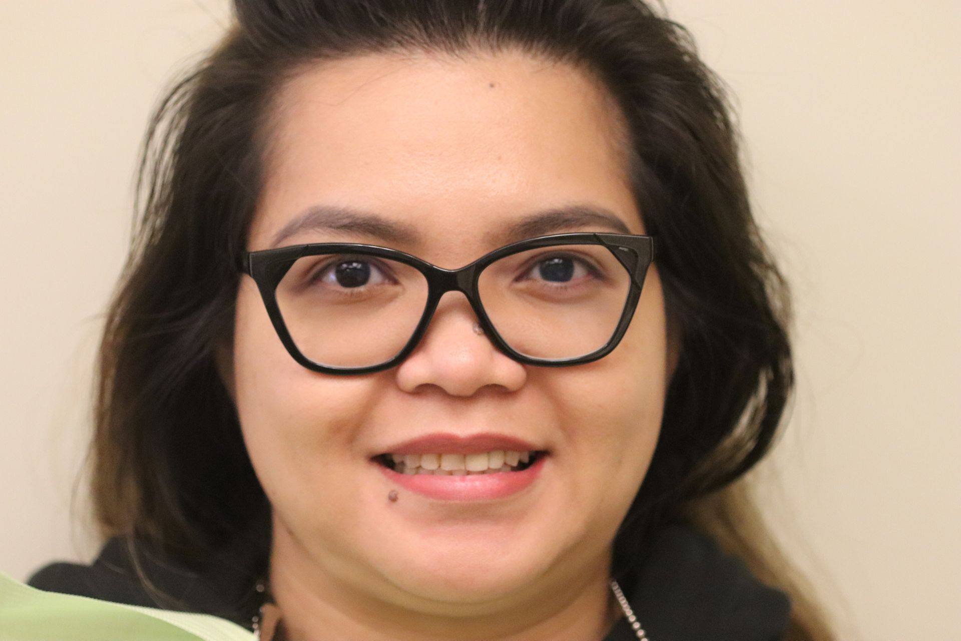 Case 3 before treatment: smiling woman wearing glasses