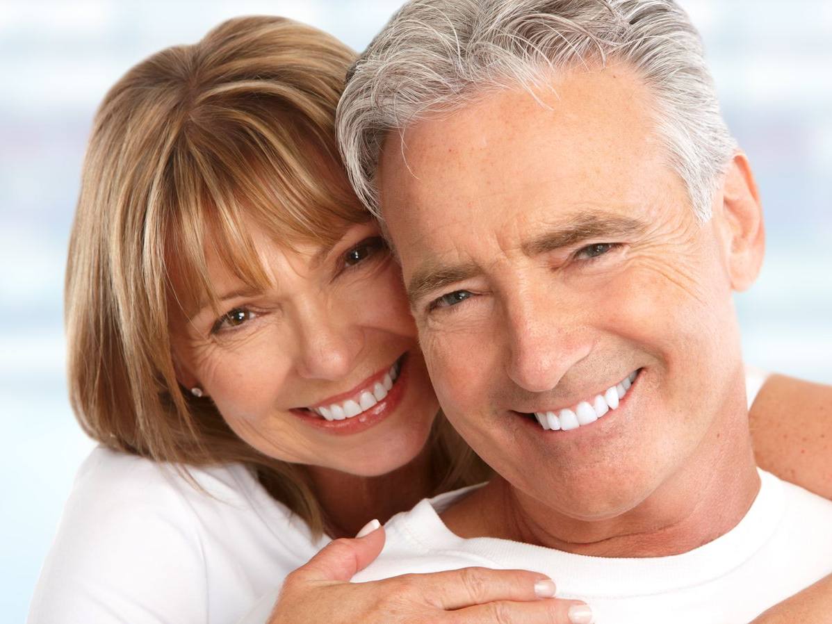 Older couple smiling together cheek to cheek